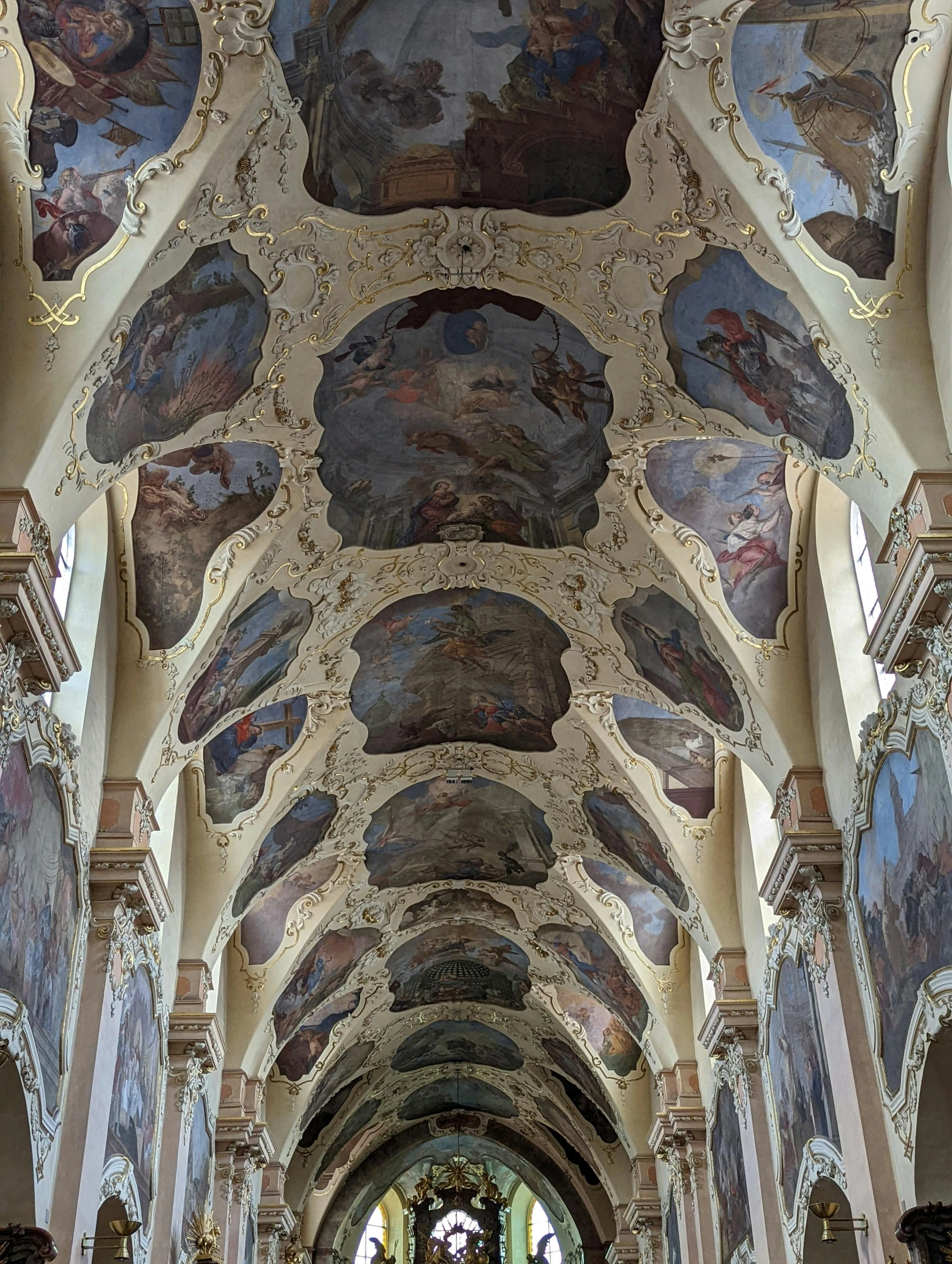 an ornate and very large church with elaborate paintings on the ceiling