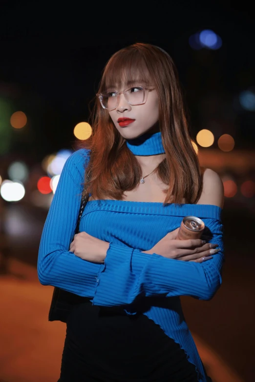 a young lady wearing a blue dress and posing for the camera