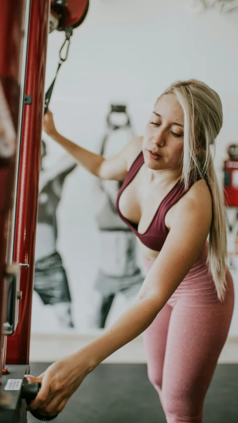 a woman performing h ups at a crossfit gym