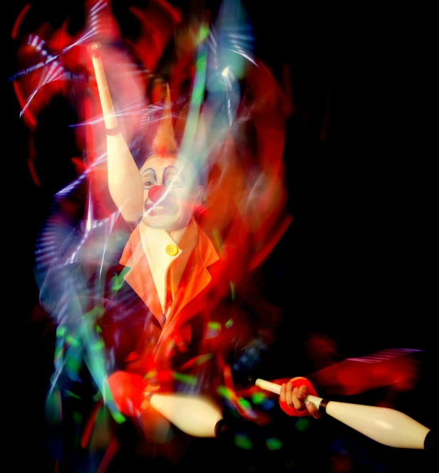 a woman dressed in red and white juggling