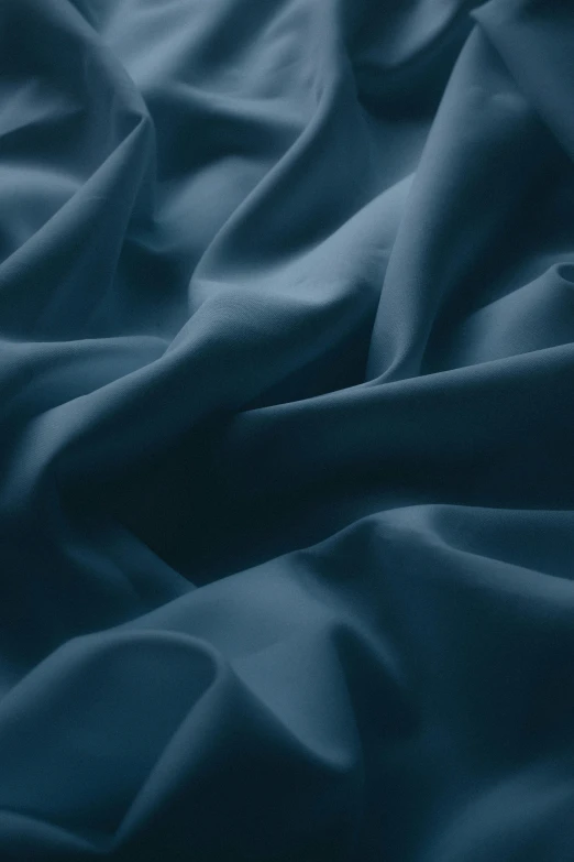 dark blue material that resembles a blanket with some small folds