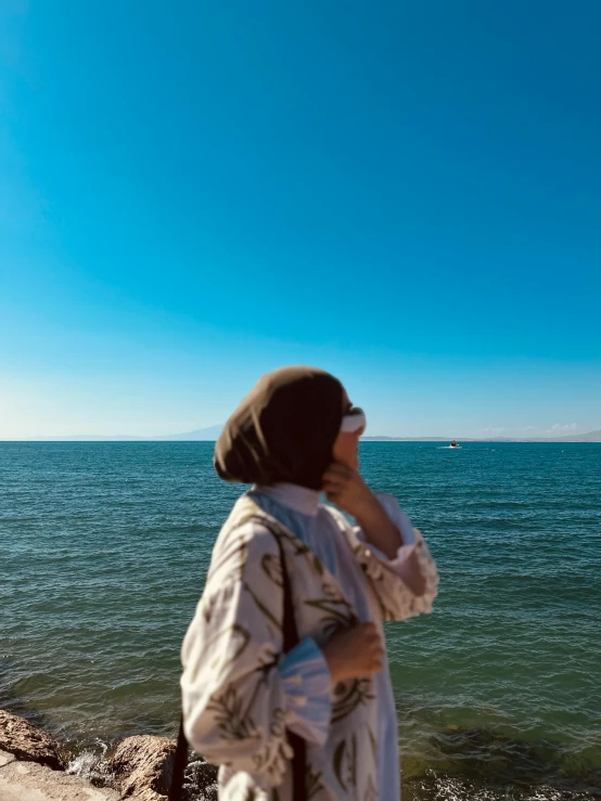 a woman is looking out into the water