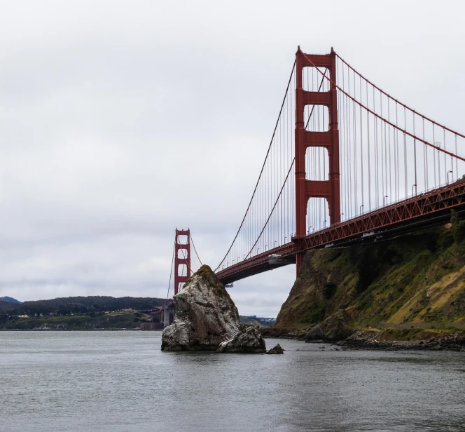 a boat sails under the golden gate bridge