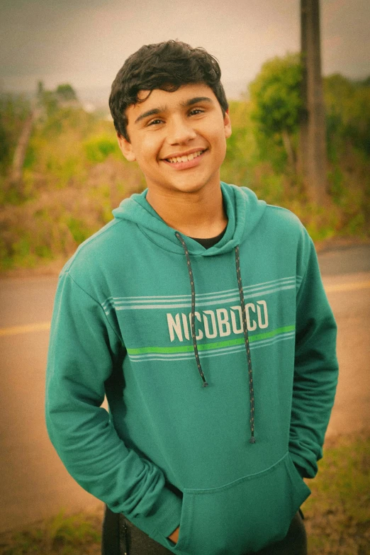 a smiling teenage boy is posing for a pograph