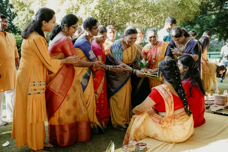 a group of women are gathering around each other for a religious ceremony