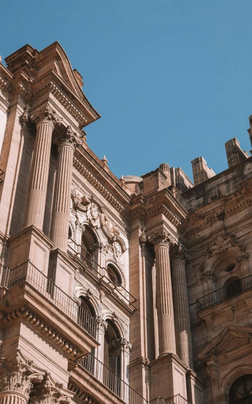 a view of a large stone building from the ground