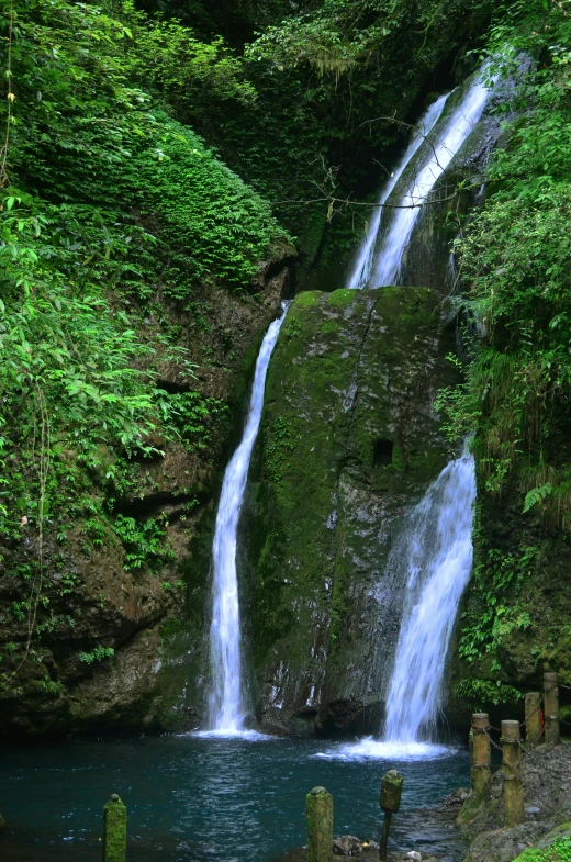 a waterfall falling down into a body of water