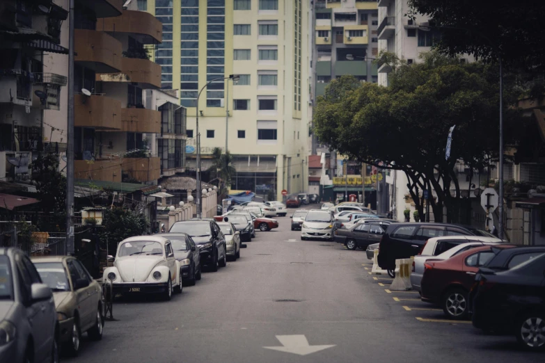 the view down a street where cars are parked