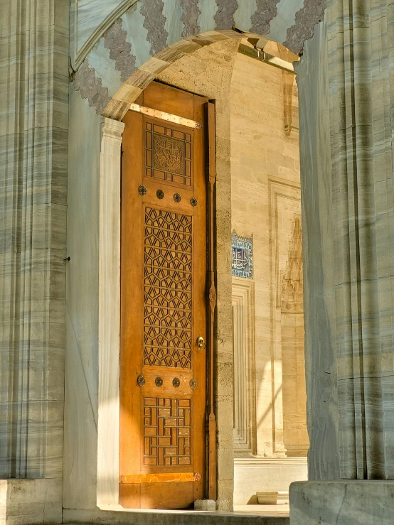 an intricately decorated door in a courtyard with columns