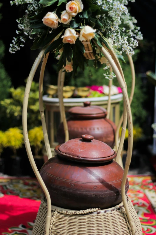 small pots on a table with some flowers on them