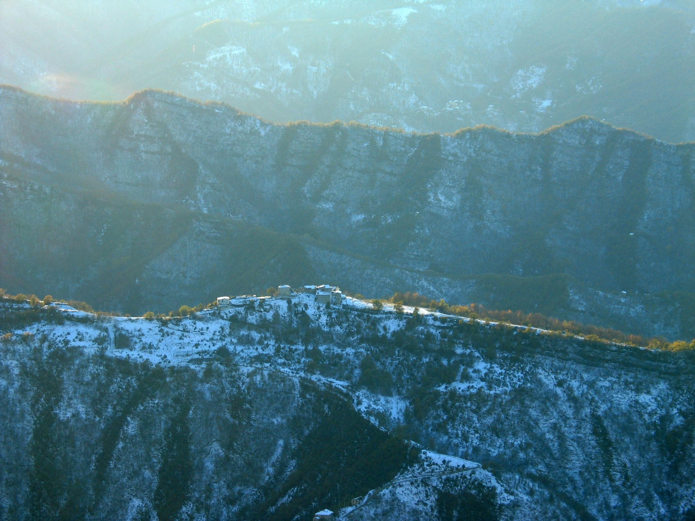 a large mountain with a snow covered hillside