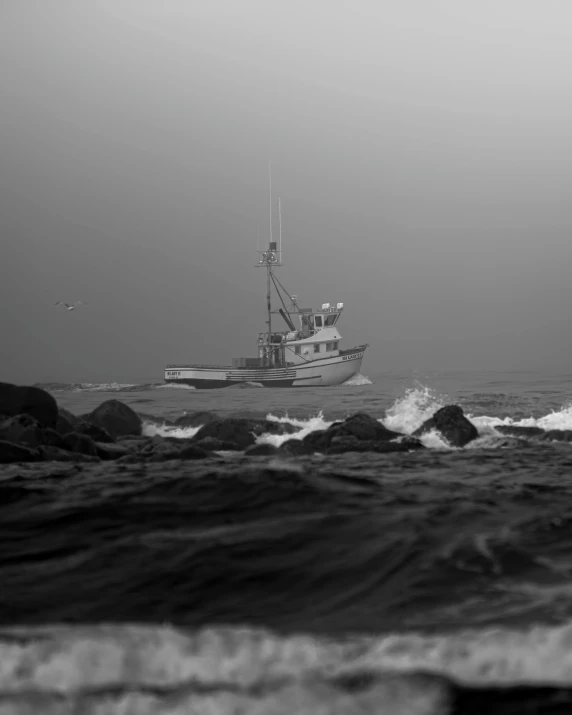 a boat sailing in the ocean with strong waves