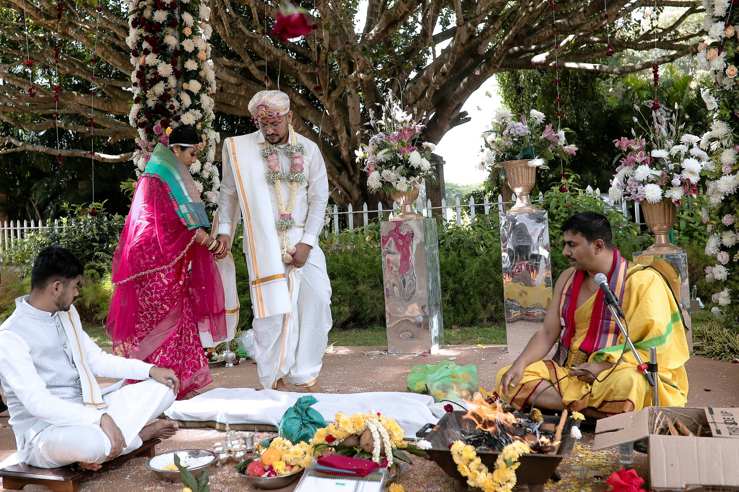 two people wearing indian attire sitting on the ground