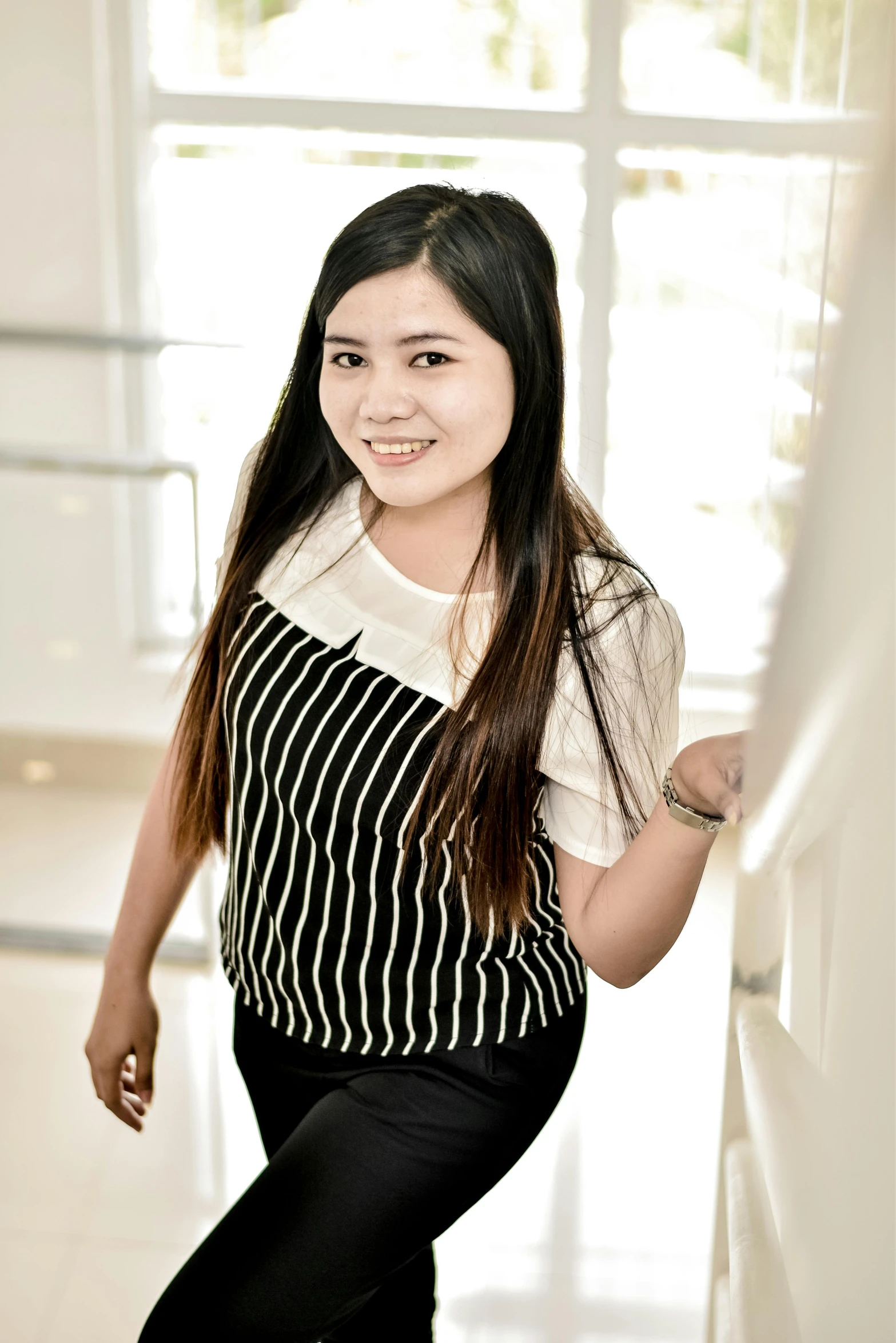 a girl wearing an apron and smiling for a po