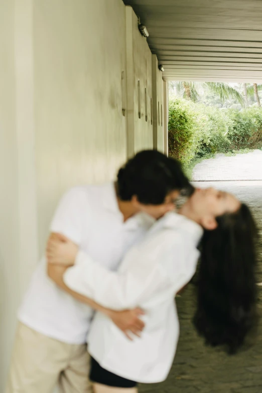 a man and woman are walking down an aisle holding each other