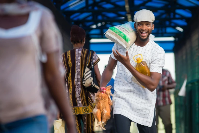 an image of man carrying orange juice on a busy street