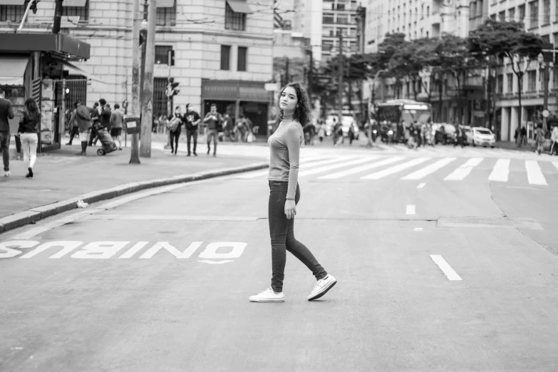 a woman standing in the middle of a street