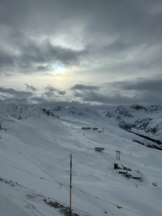 the sun shines through clouds in the distance as we climb toward the mountains