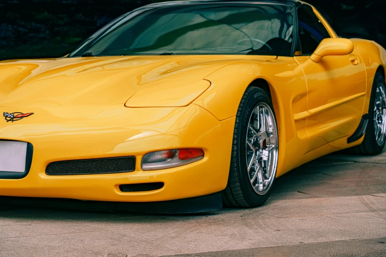 a chevrolet sports car sits parked in a driveway