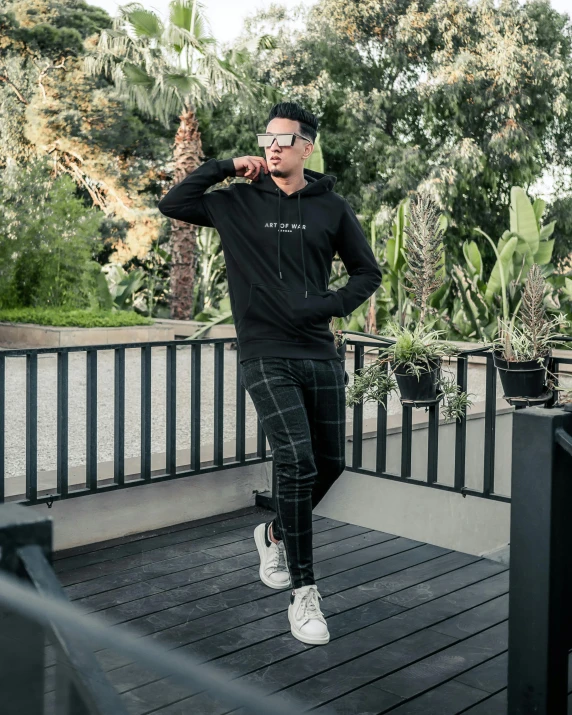 man walking with a cigarette while wearing white shoes