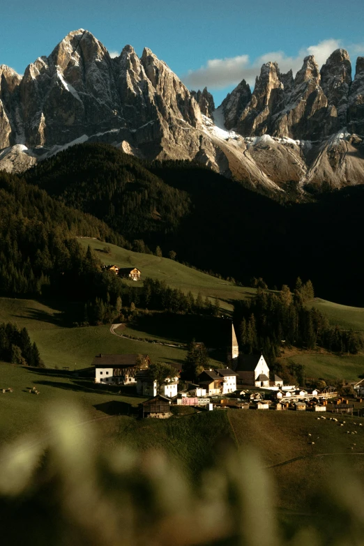 some mountains with a village and houses in the middle