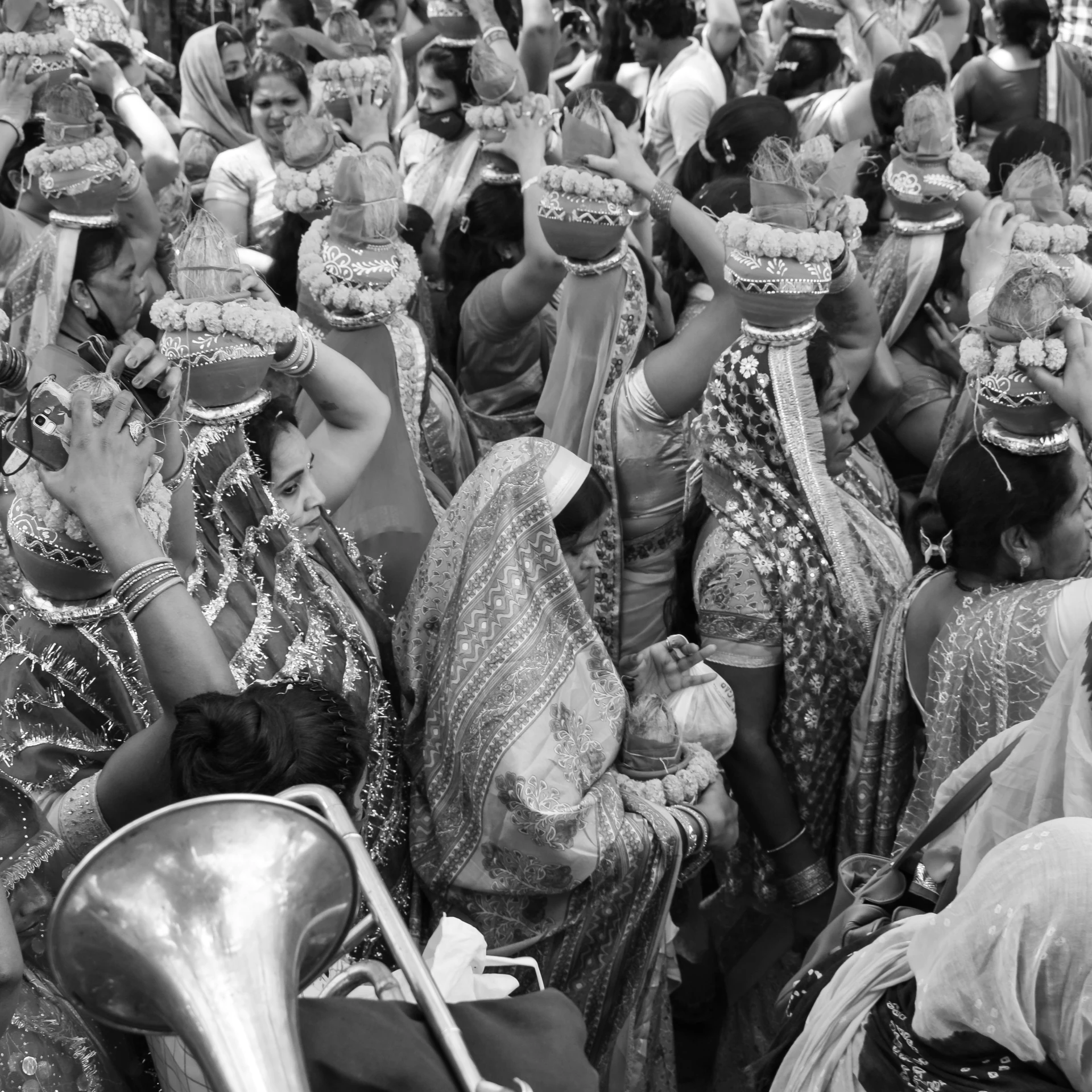 people sit on a crowded street with musical instruments