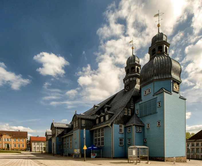 a view of a large church with clocks and two towers