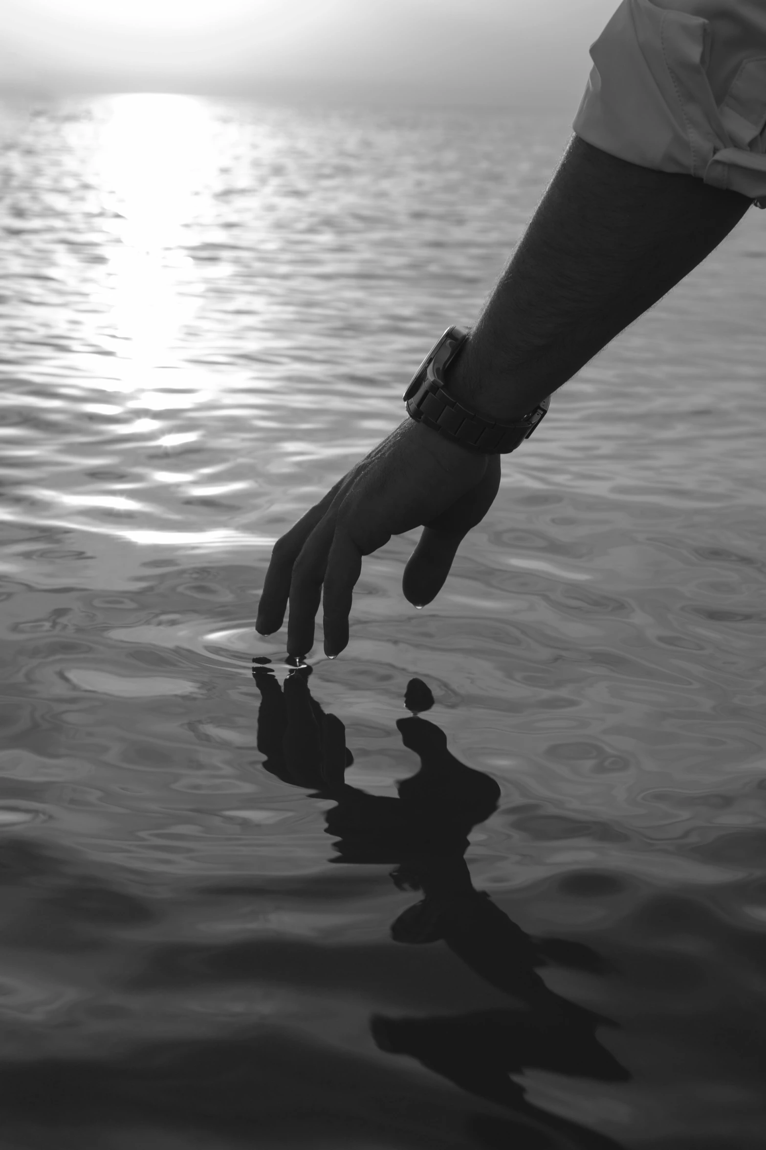 a person reaching for soing in the water