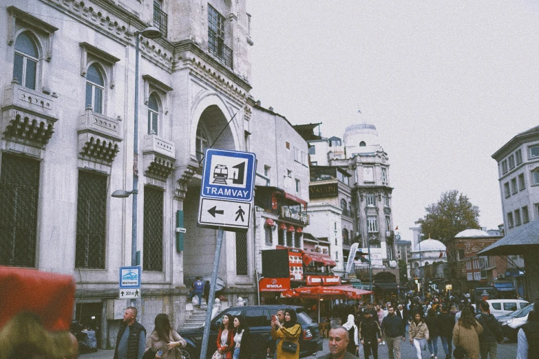 a city street has many people and cars