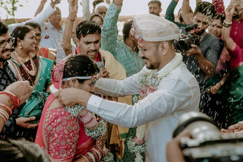 a bride and groom are throwing rice at the other