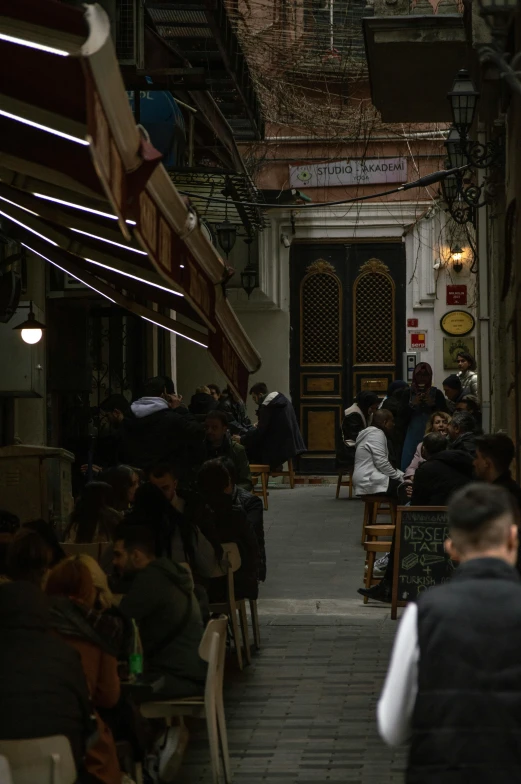 a large group of people standing on the inside of a building