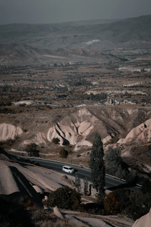 two buses driving down a rural road in the desert