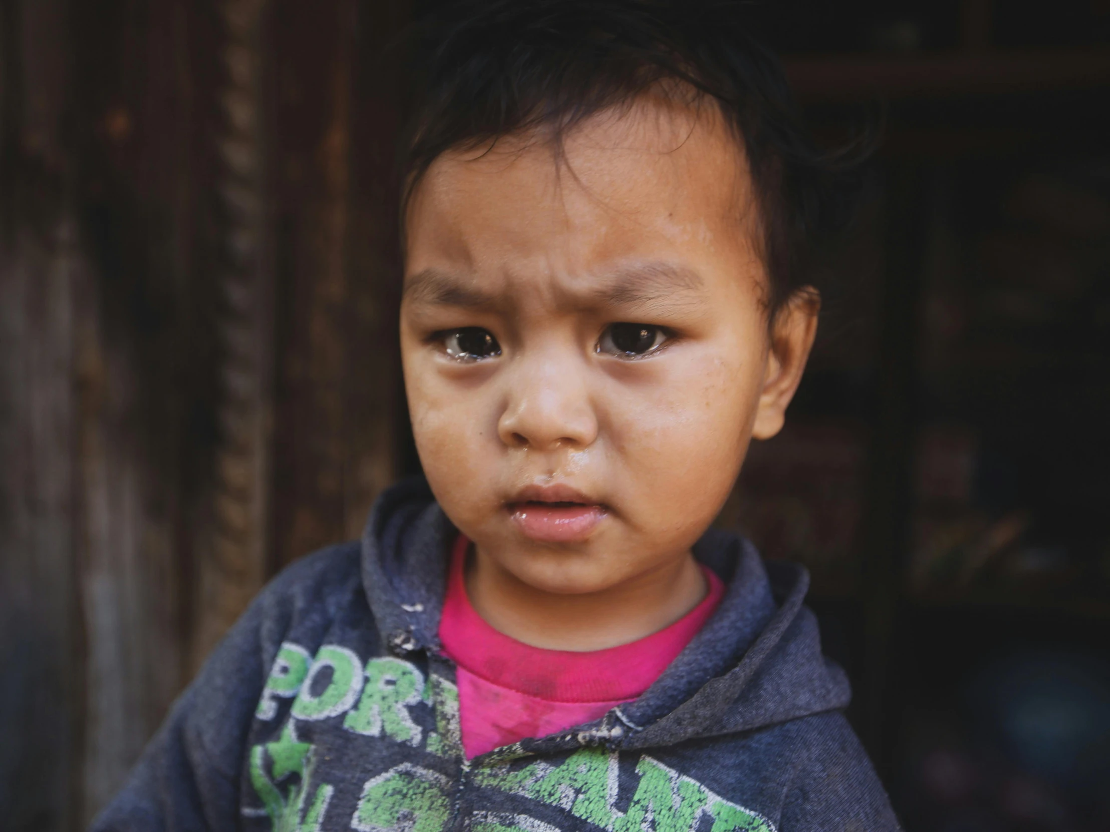 a little child staring into the camera