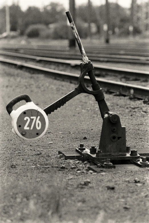 a rusty wrench leaning on the tracks
