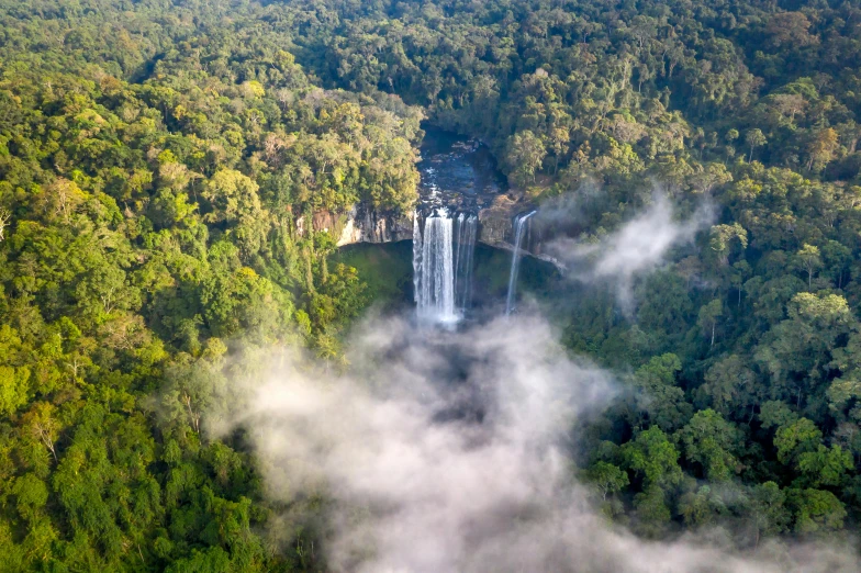 a very large waterfall in the middle of a jungle