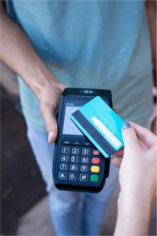 man holding a credit card and a pos terminal terminal