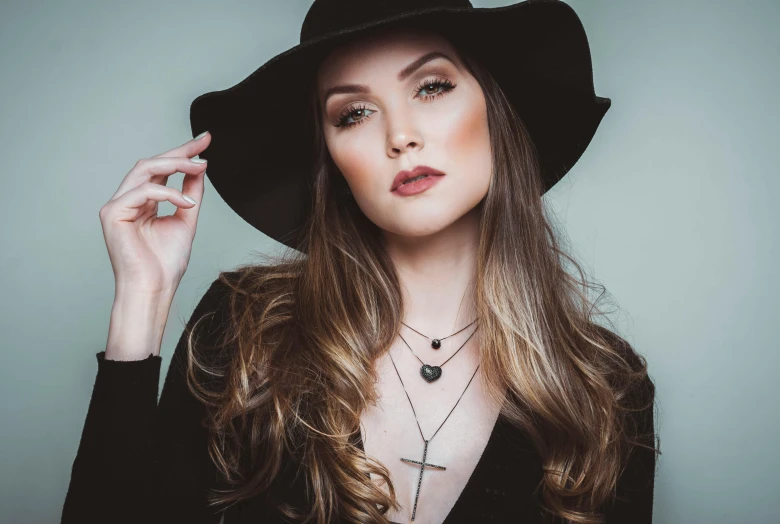 a woman with long hair and a big black hat