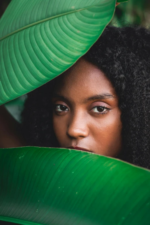 a young woman with a long curly hair wearing an afro