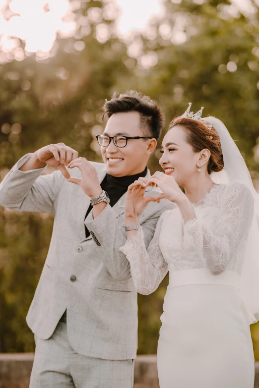 the bride and groom have one holding their wedding rings