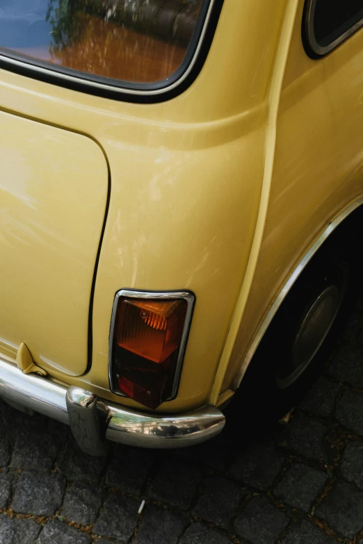 the front of an old car parked on the street