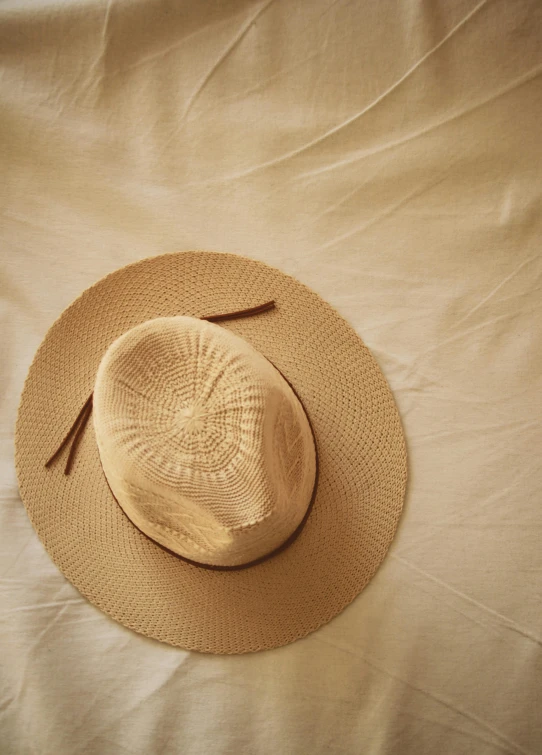 a straw hat lying on top of a blanket