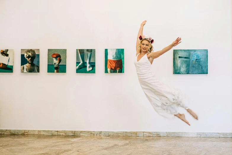 a girl in white dress in air over painting