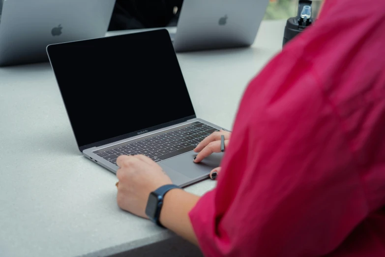 a person is working on an apple laptop