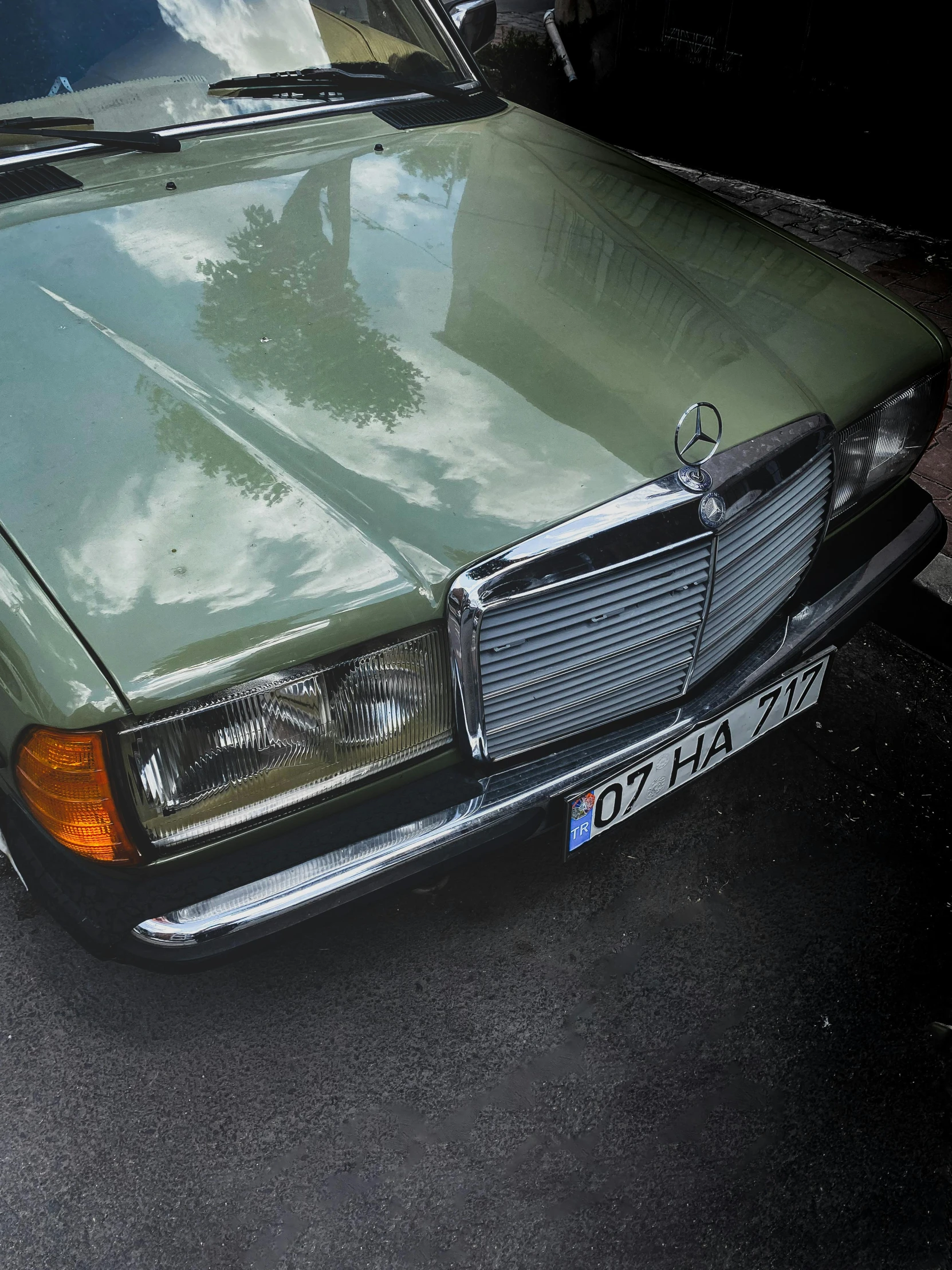 an older mercedes parked in a parking lot