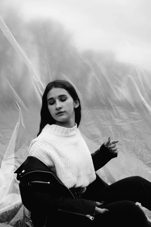 woman in black and white outfit sitting on a tarp