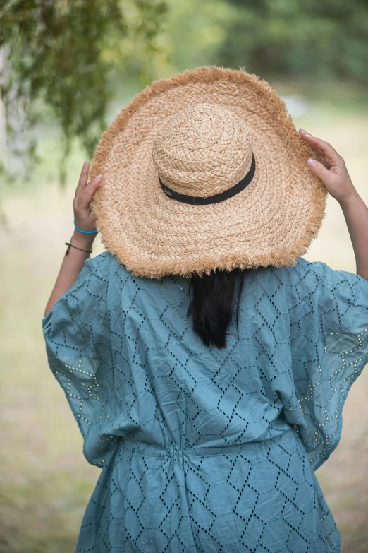 a woman with a straw hat on her head