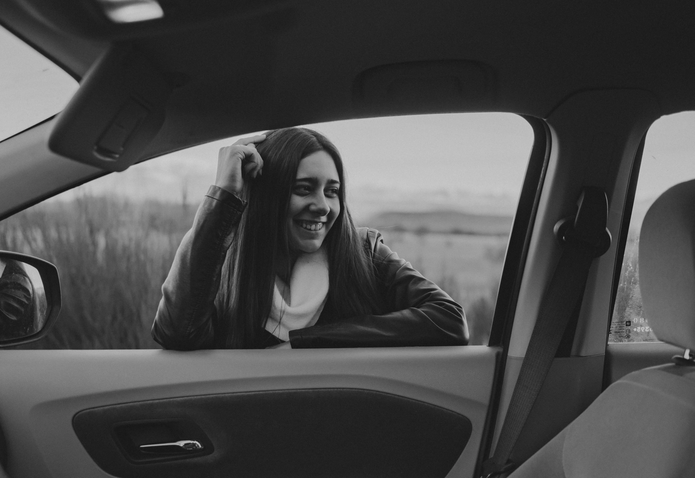 a woman sitting in the drivers seat of a car