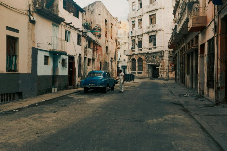 an old street has cars parked along it