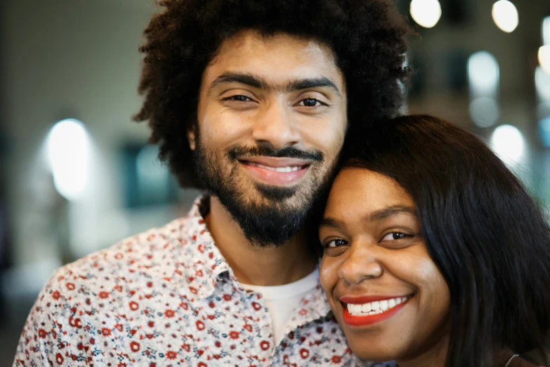 there is a young man with curly hair and a woman who is smiling