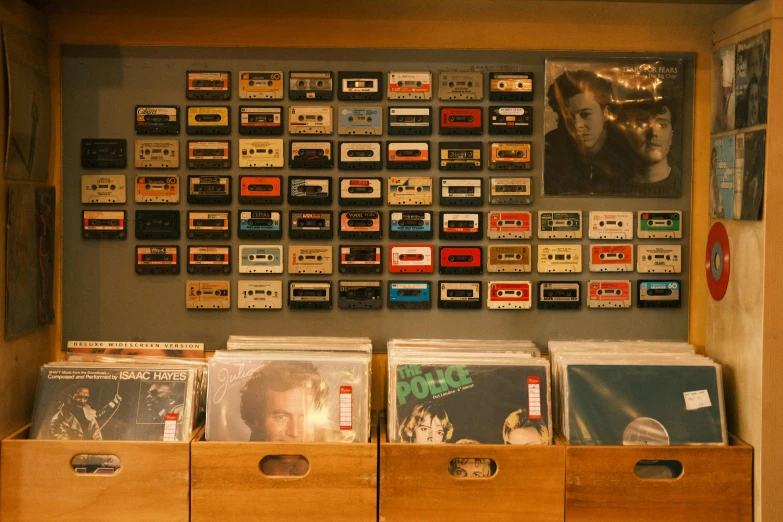 a wall with old cassette tape drives and games in bins